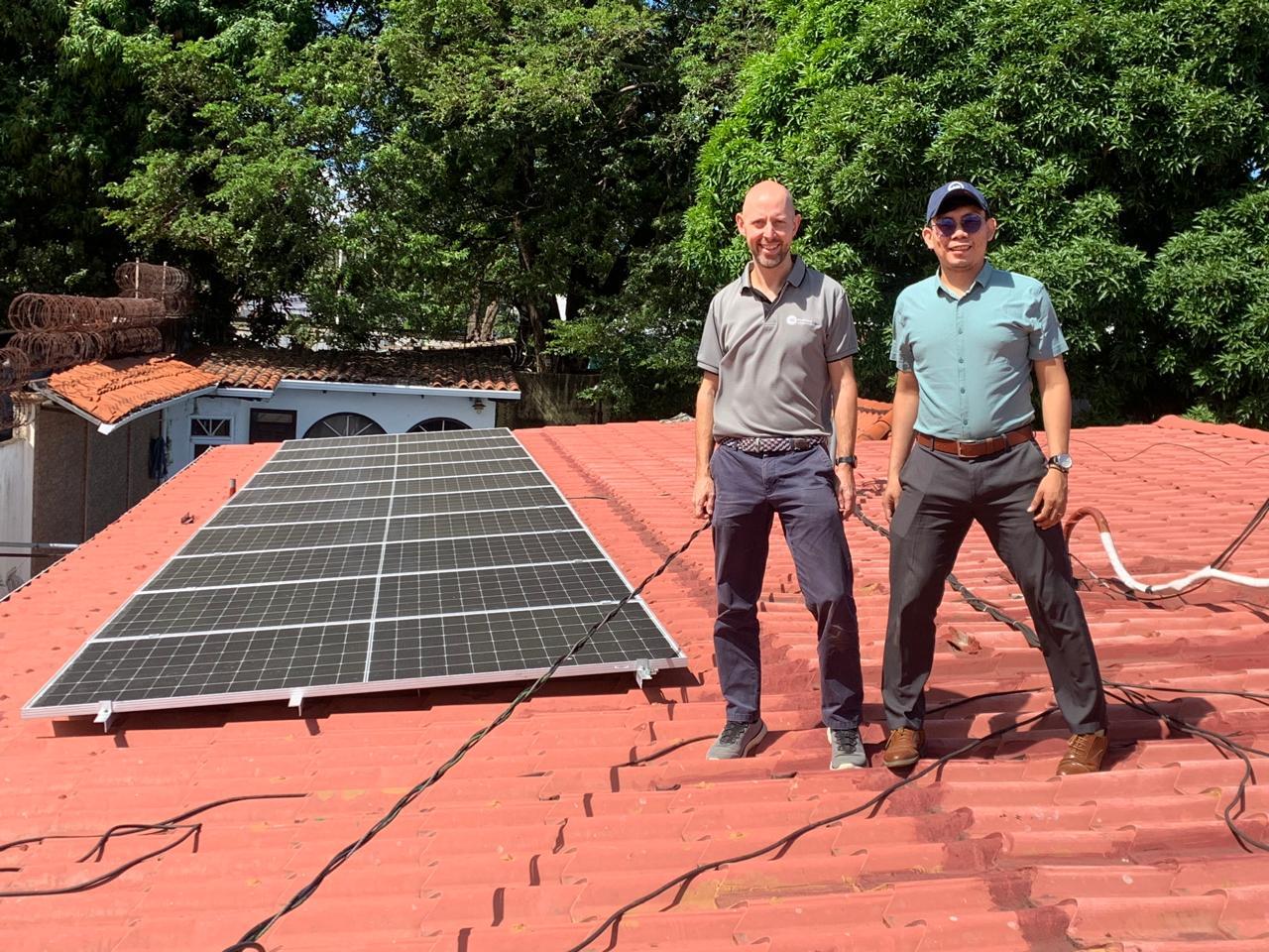 Solar smiles Two EMI Staff inspect the solar panel installation at EMI Nicaragua.