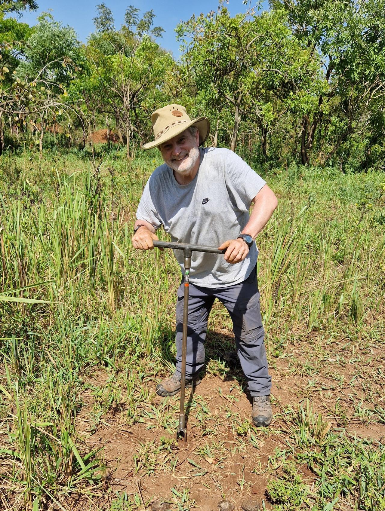 Project Trip Volunteer doing water percolation tests on site