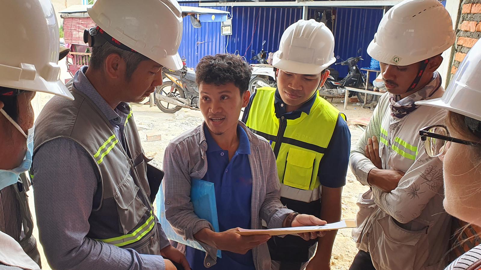 Construction management team reviews plans. 