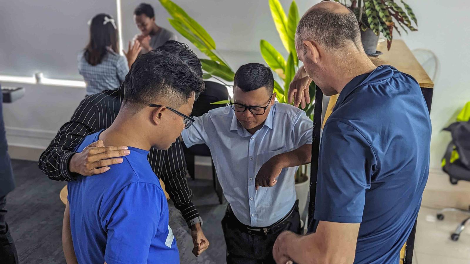 A group of people praying. 