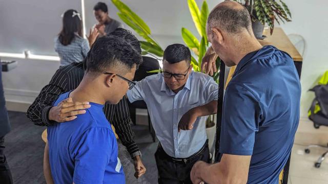 A group of people praying. 